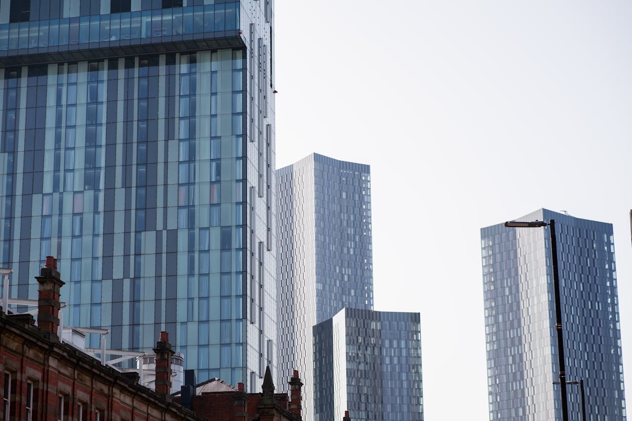 A view of modern skyscrapers in Manchester, showcasing urban architecture and city life.